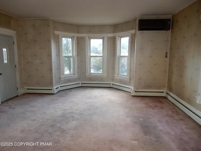 a view of an empty room with a fireplace
