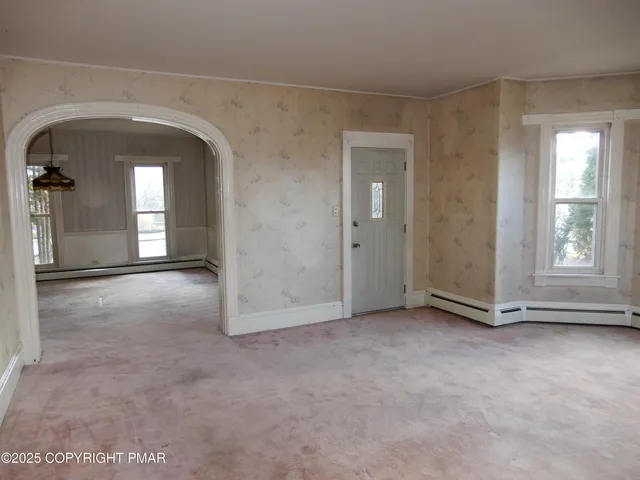 a view of a livingroom with wooden floor and a window