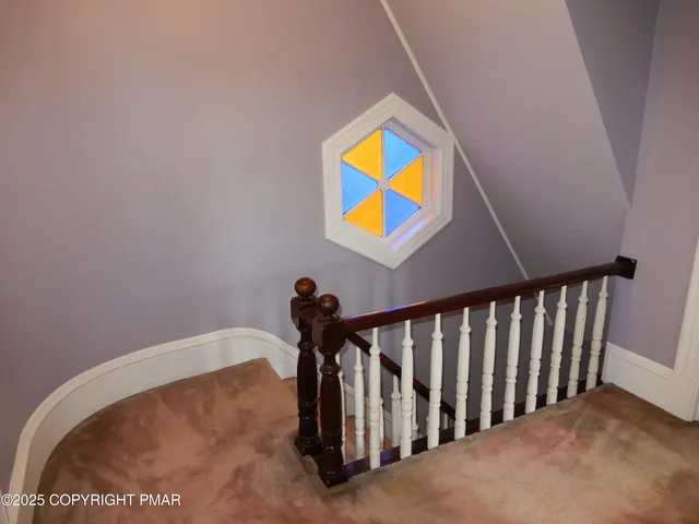 a view of a chandelier in big room and a bathroom