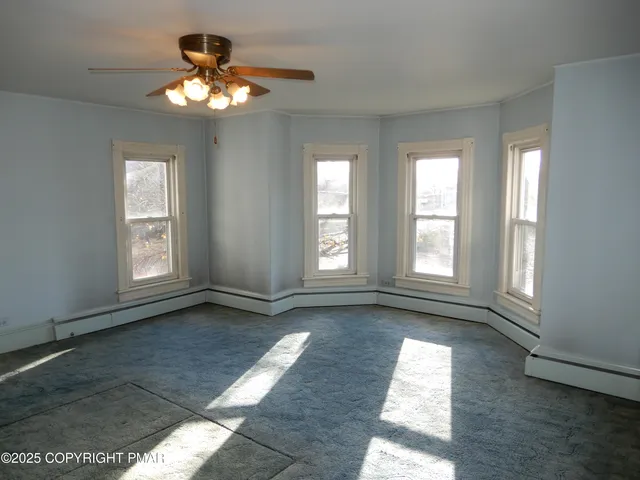 wooden floor and window in an empty room