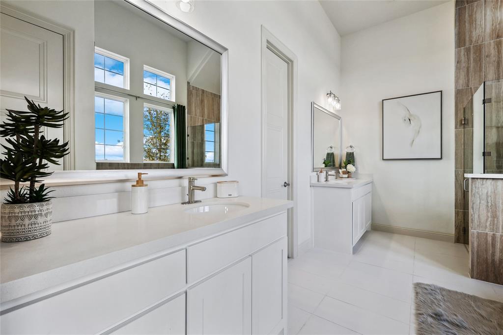 1604 Casting Ridge Mesquite, TX 75181 - Photo 20 of 38 Dual vanity bathroom featuring light-toned flooring, white cabinetry, and a large wall-mounted mirror