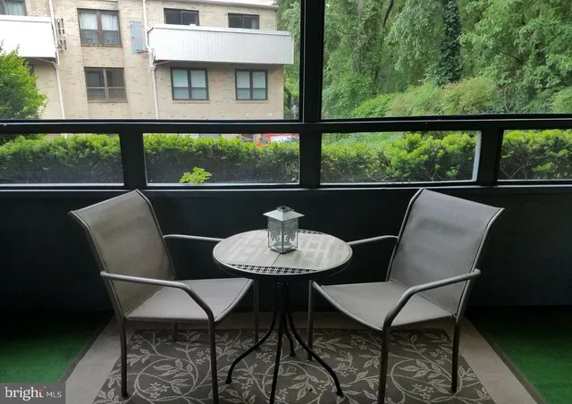 a view of a chairs and table in the balcony