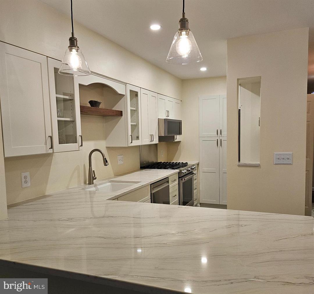 304 B Forbes Street Annapolis, MD 21401 - Photo 2 of 12 a kitchen with stainless steel appliances granite countertop a sink a stove and a refrigerator