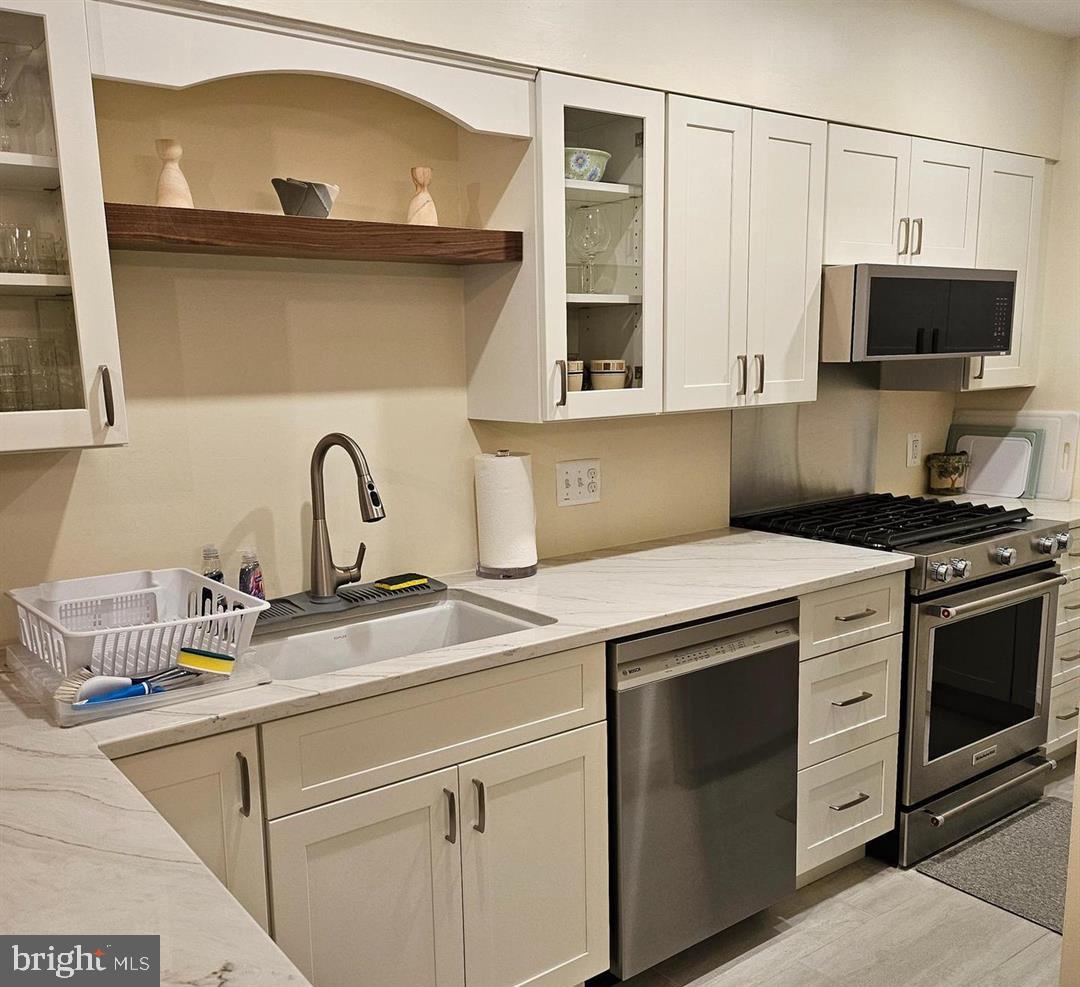 304 B Forbes Street Annapolis, MD 21401 - Photo 3 of 12 a kitchen with a stove and a microwave