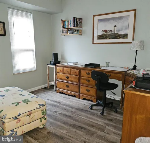 a bedroom with a bed and a desk