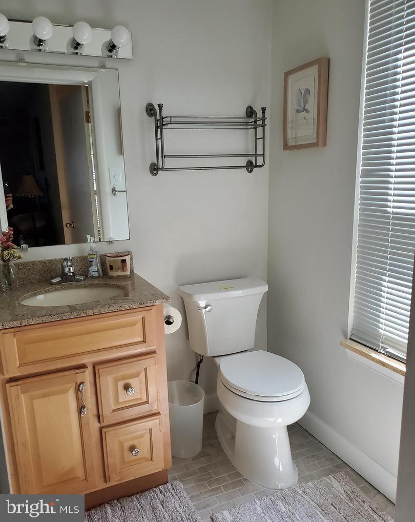 304 B Forbes Street Annapolis, MD 21401 - Photo 10 of 12 a bathroom with a toilet a sink and mirror