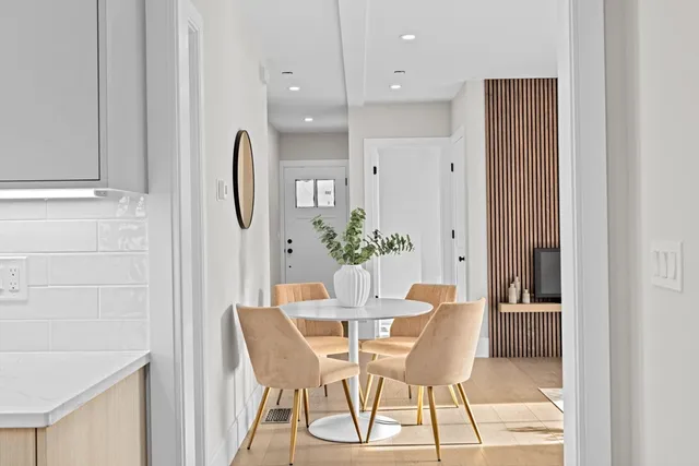 a view of a dining room with furniture and wooden floor