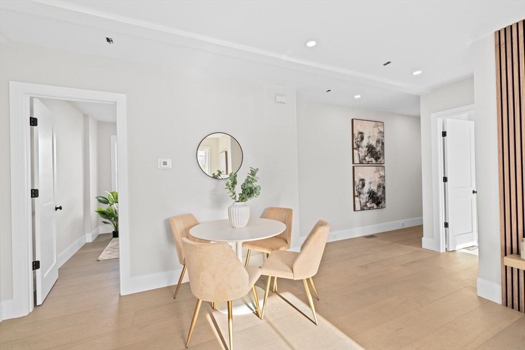340 Baker Street, Unit 1 Boston, MA 02132 - Photo 15 of 41 a dining room with furniture and mirror