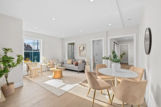 a living room with fireplace furniture and a potted plant