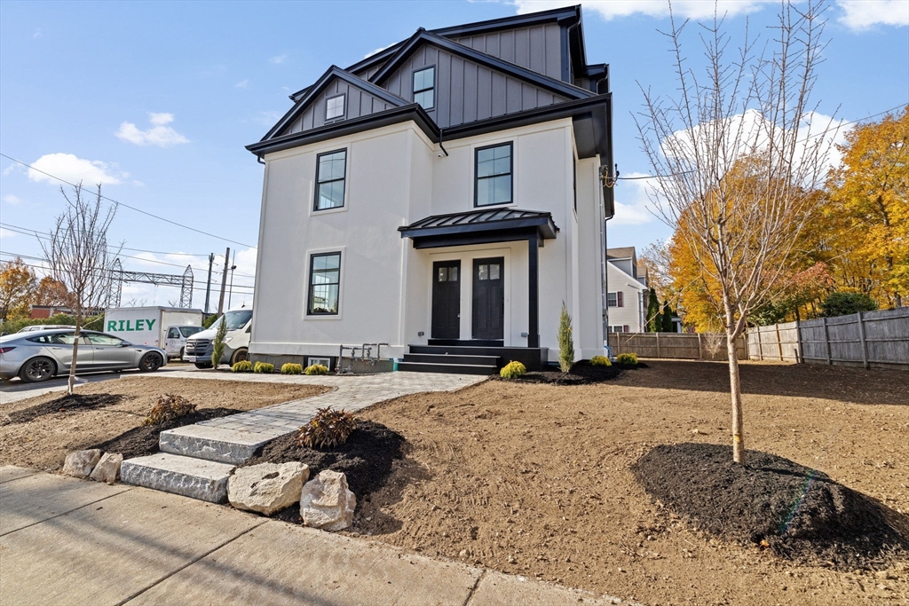 340 Baker Street, Unit 1 Boston, MA 02132 - Photo 2 of 41 a front view of a house with a yard