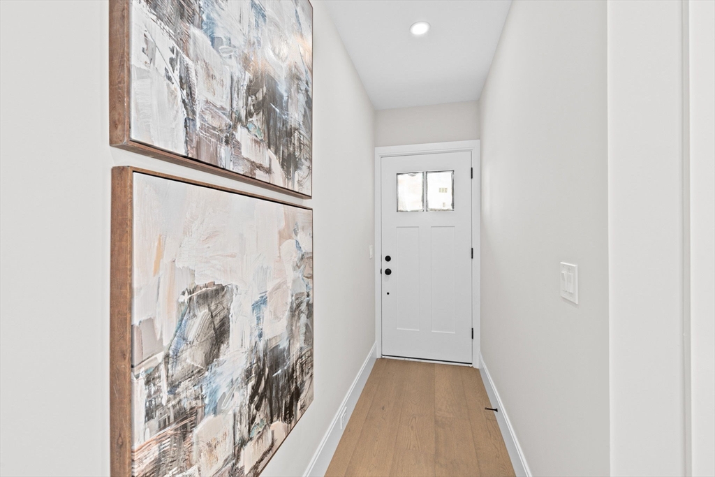 340 Baker Street, Unit 1 Boston, MA 02132 - Photo 21 of 41 a view of a hallway with wooden floor and a window