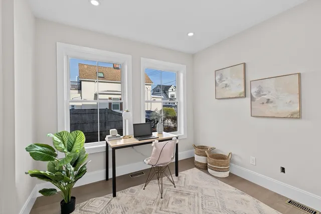 a living room with furniture flowerpot and a potted plant