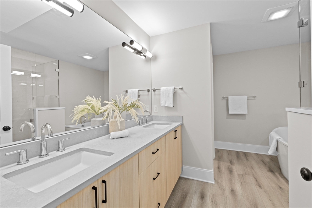 340 Baker Street, Unit 1 Boston, MA 02132 - Photo 27 of 41 a bathroom with a double vanity sink mirror and shower