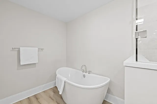a white bath tub sitting next to a white sink