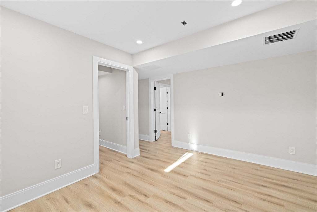 340 Baker Street, Unit 1 Boston, MA 02132 - Photo 31 of 41 a view of an empty room with wooden floor