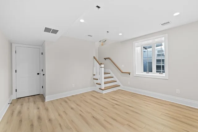 a view of an entryway with wooden floor