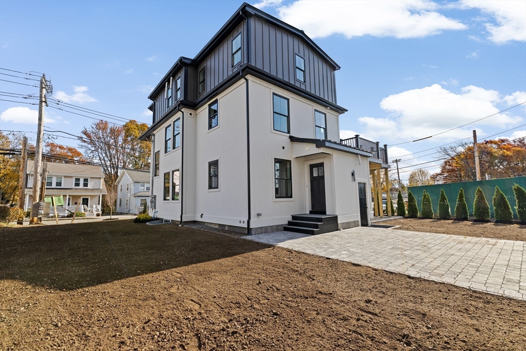 340 Baker Street, Unit 1 Boston, MA 02132 - Photo 36 of 41 a front view of a house with a yard