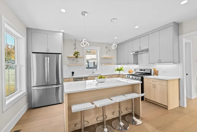a kitchen with white cabinets and stainless steel appliances