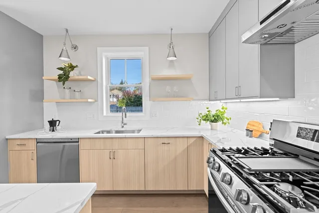 a kitchen with a sink stove and wooden cabinets