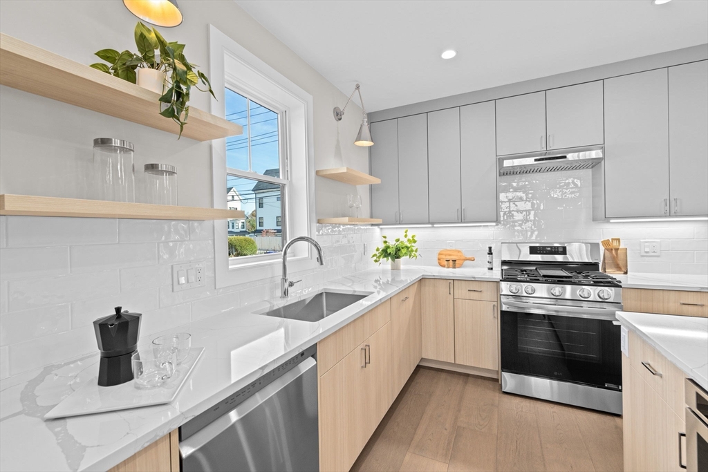 340 Baker Street, Unit 1 Boston, MA 02132 - Photo 6 of 41 a kitchen with a sink stove and cabinets