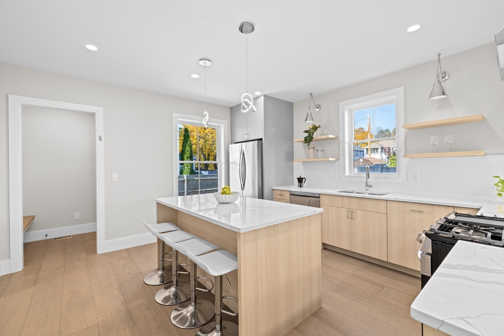 340 Baker Street, Unit 1 Boston, MA 02132 - Photo 8 of 41 a kitchen with a sink appliances and cabinets