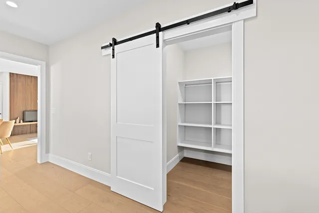 a view of a room with wooden floor