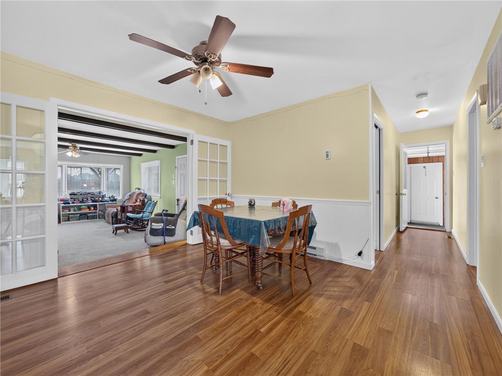 3046 Ridon Court Bethlehem, PA 18020 - Photo 18 of 41 A welcoming dining area features rich wood flooring, leading into a spacious living room through elegant French doors.