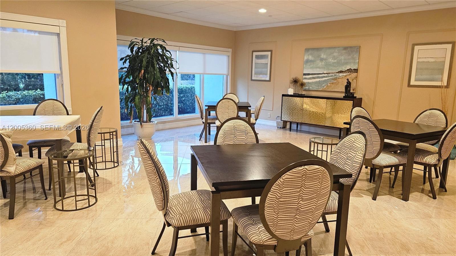 4001 North Ocean Boulevard, Unit 702 Boca Raton, FL 33431 - Photo 45 of 56 a view of a dining room with furniture and chandelier
