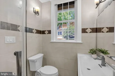 a white toilet sitting next to a bathroom sink