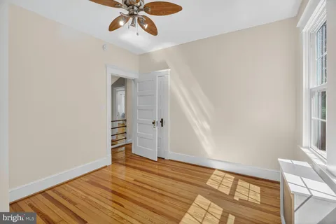a view of empty room with wooden floor