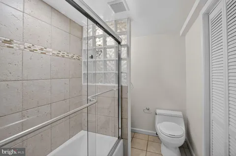 a bathroom with a toilet and shower