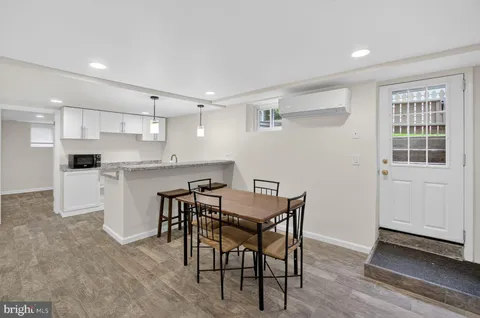 a view of kitchen with cabinets table and chairs