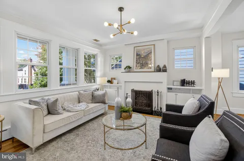 a living room with furniture a window and a fireplace