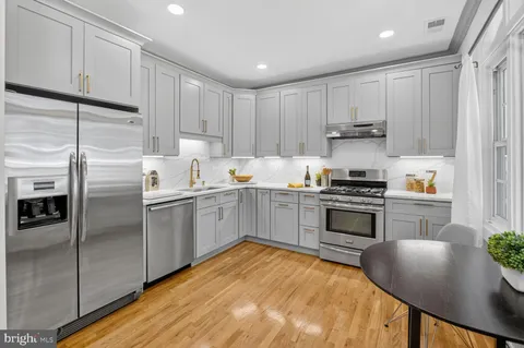 a kitchen with a refrigerator sink and cabinets