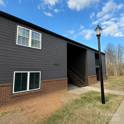 a backyard of a house with barbeque oven table and chairs