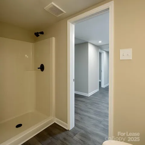 a view of kitchen with stove and cabinets