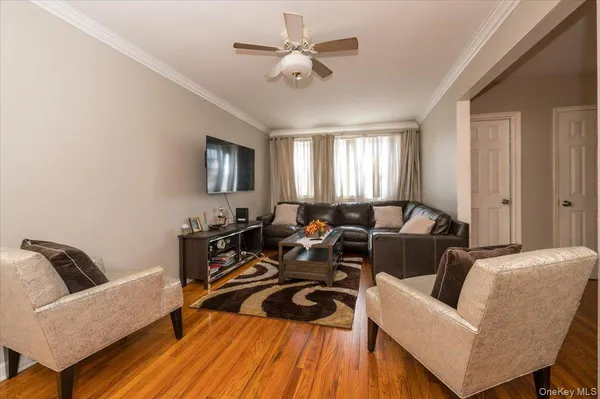 a living room with furniture and a ceiling fan