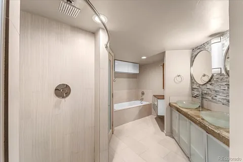 a bathroom with a granite countertop sink a toilet and bathtub