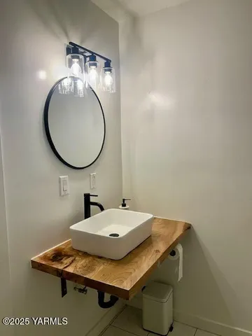 a bathroom with a sink and mirror