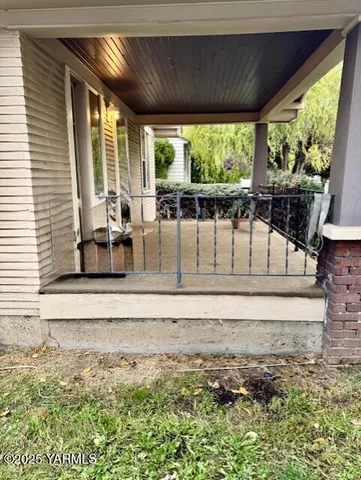 a view of a porch with chairs and backyard