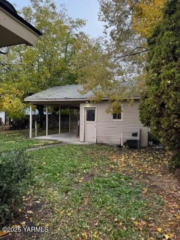 a house with green field in front of it