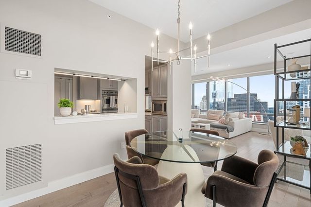 a dining room with furniture a chandelier and window