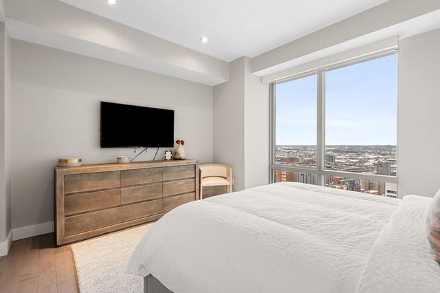 a bedroom with a bed and a flat screen tv