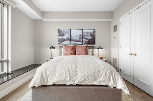 a bedroom with a bed and large window