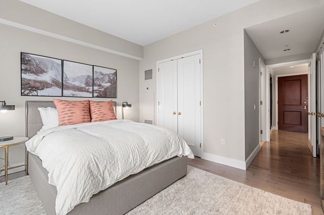 a bedroom with a bed and large window