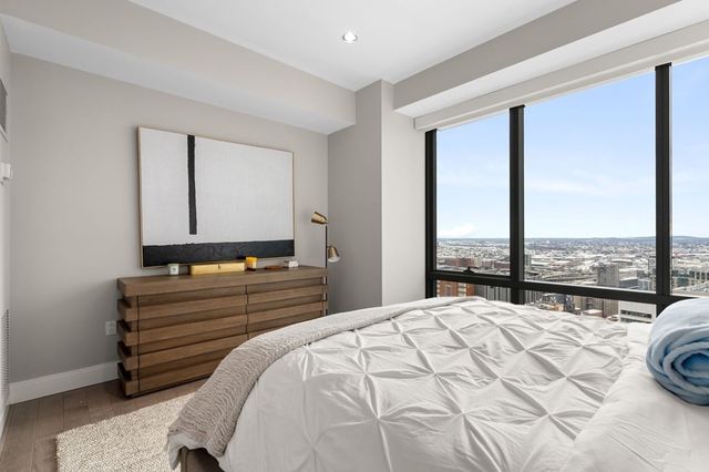 a bed room with a bed and a large window