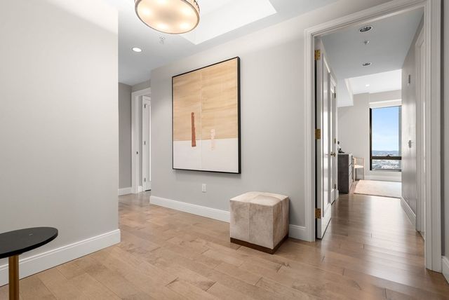 a view of a room with wooden floor and windows