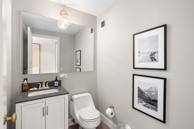 a bathroom with a toilet a sink and a mirror