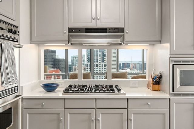 a kitchen with granite countertop a sink and cabinets