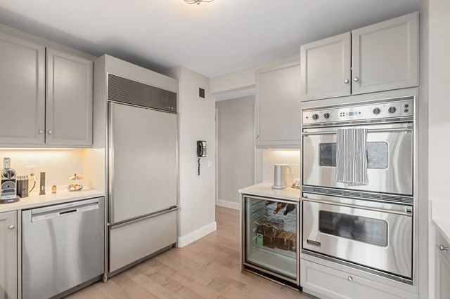 a kitchen with cabinets and stainless steel appliances